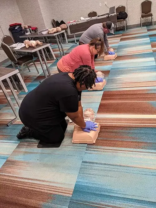 People giving chest compressions